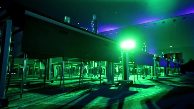 Bottles with water and transparent glasses on tables in meeting or conference hall. Getting rea