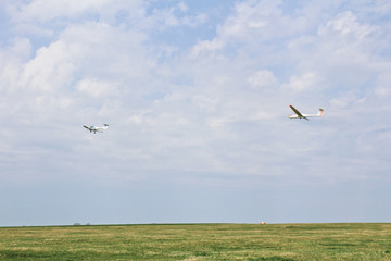 Ultralight plane pull glider on sky