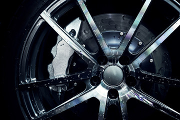 Modern metal rims on car at dark - Powered by Adobe