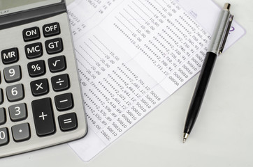 Bank account passbook with pen and calculator