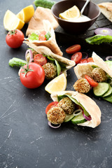 Falafel with sesame and vegetables in pita. Eastern cuisine, healthy snack 
