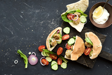 Falafel with sesame and vegetables in pita. Eastern cuisine, healthy snack 
