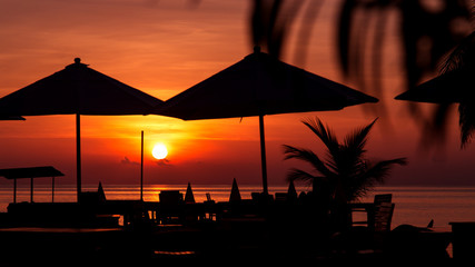 Parasol silhouette at beautiful sea tropical sunset