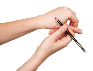 Black eyeliner pencil in female hand isolated on white.