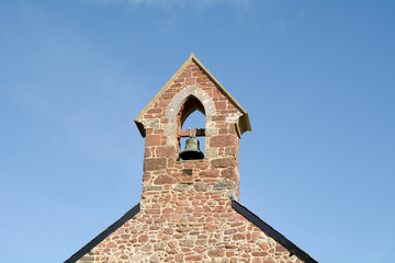 The bell tower at Saint Nicholas Church Ringmore in the Parish of Shaldon in Devon England