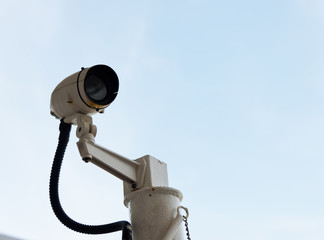 CCTV security camera isolated on sky background.