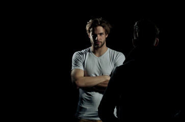 Two handsome men standing opposite