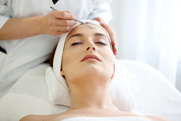 Find Similar  Get a Comp  Save to LightboxSpa salon: young beautiful woman having facial treatment.