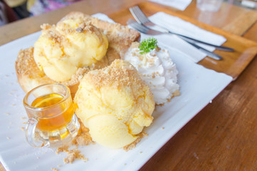 honey Toast and ice cream on white dish wood table