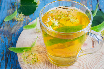 Cup with linden tea and flowers. concept of treatment cold and flu