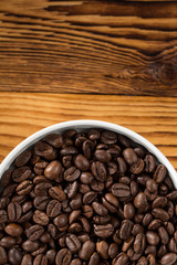 Arabic. High angle cropped shot of a bowl full of freshly roasted coffee beans copyspace above.