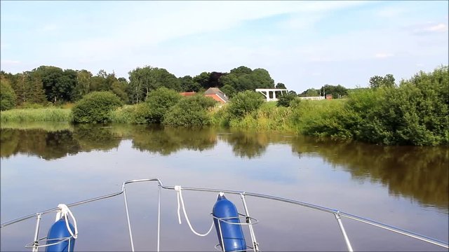 boat ride along a river, idyllic landscape 
