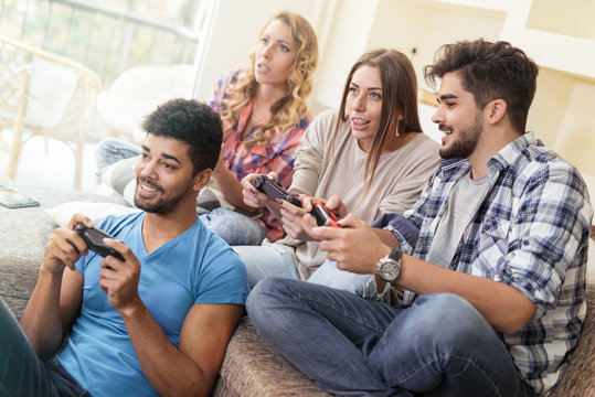 Friends having fun on the couch with video games
