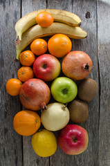 Naklejka na ściany i meble Fruits in basket on wooden background