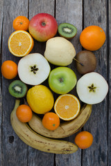 Fruits in basket on wooden background