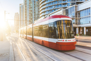 Fototapeta na wymiar Modern tram in Toronto downtown at sunset