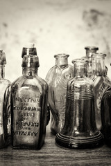 Coloured glass bottles on a rustic background