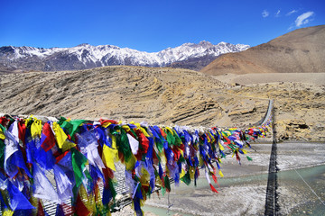 Suspension bridge between Lower Mustang and Upper Mustang with lot of colorful buddhist praying...