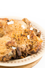 Fried pork chops served on the plate isolated over white background