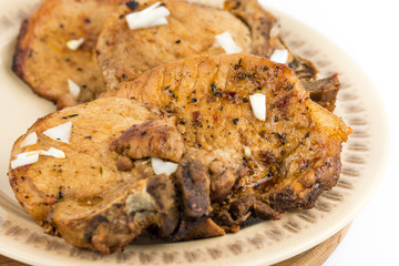 Fried pork chops served on the plate isolated over white background