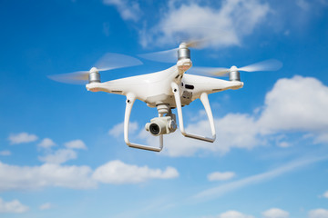 Quadrocopter drone with the camera against the blue sky