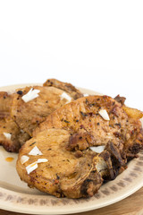 Fried pork chops served on the plate isolated over white background