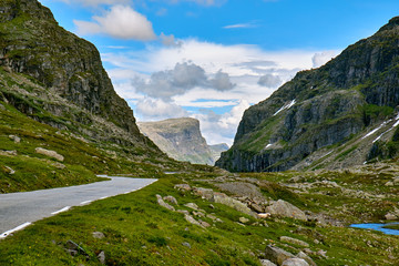 Road running between the mountains in Telemark, with a peak seen at the far
