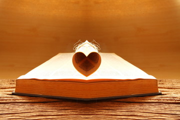 Old book put on the brown color hard wood represent book background concept related idea.