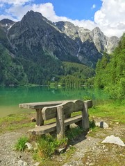 bench with table at the mountain lake