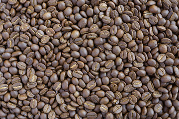 Roasted coffee beans on grunge wood background