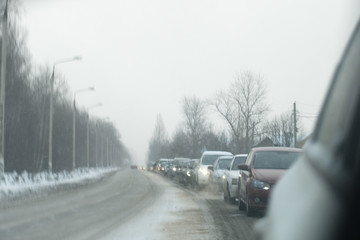 Blurred view from a car mirror to a traffic jam