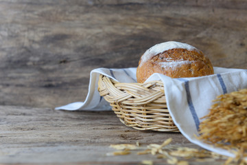 Whole wheat bread set in bamboo basket on wooden table top background