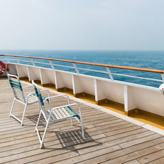row of sun chairs  on the ship deck