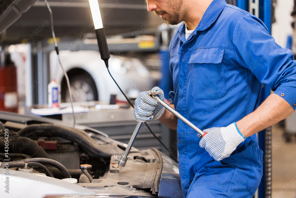 Sticker mechanic man with wrench repairing car at workshop