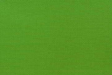 Close-up view of the green color natural cloth. Aida texture for the background.