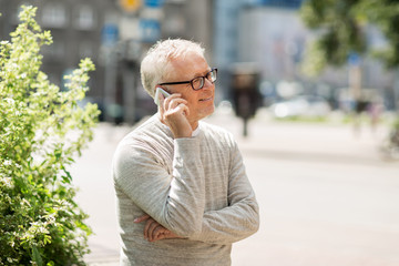 happy senior man calling on smartphone in city