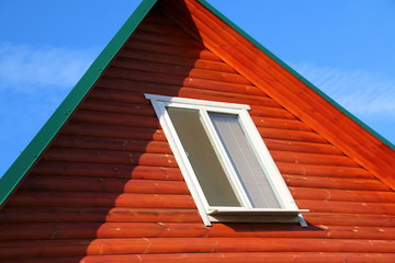Plastic window of a modern summer cottage against a blue sky
