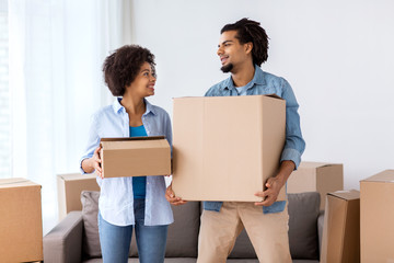 happy couple with boxes moving to new home