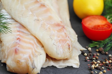 Raw fish fillet with spices and lemon