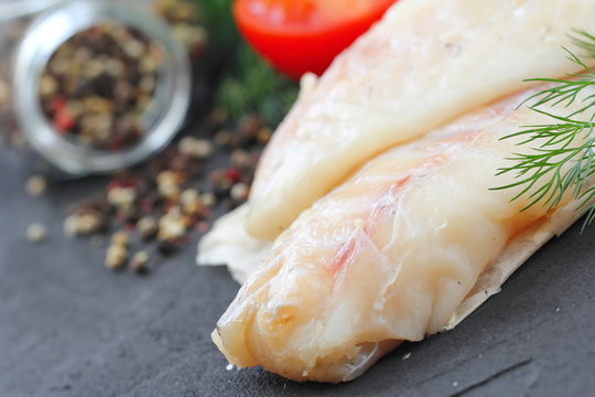 Raw fish fillet with spices and lemon