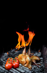 Grilling poultry quails and fresh juicy vegetables in a restaurant