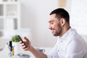 businessman with smartphone at office