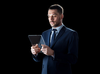 businessman in suit with transparent tablet pc