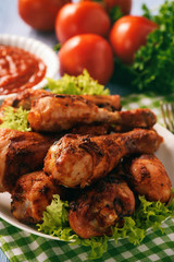 Baked chicken drumsticks with tomato dip.