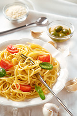 Italian pasta dish. Vegetarian spaghetti pasta with tomato sauce, garlic and olives