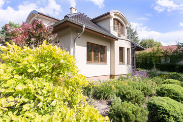 Fototapeta na wymiar Modern villa exterior surrounded by garden