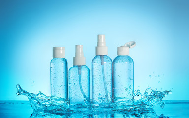 set of toiletries in a water splash on blue background © popout