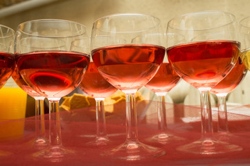 red wine in the glasses , wine for guests in the party