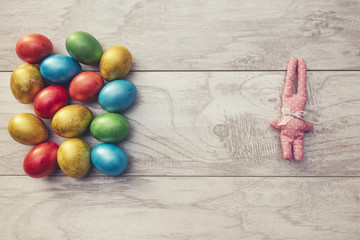 Colorful Easter holiday eggs are shiny and toy rabbit