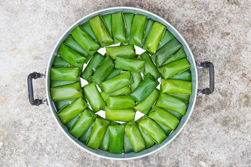 Fresh thai dessert style which insert banana and black Peas inside to sticky rice prepare to...